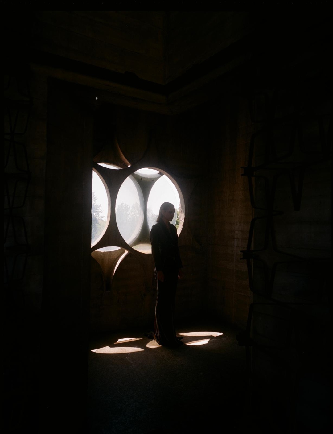 A backlit silhouette through circular oculi windows.