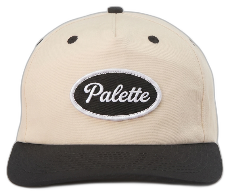 Embroidered oval patch on cream cap with black brim